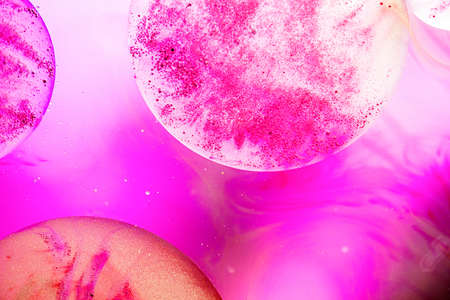 Abstract background. Oil bubbles on pink water surface