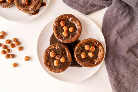 Brownie cupcake with walnut chocolate topping on white table