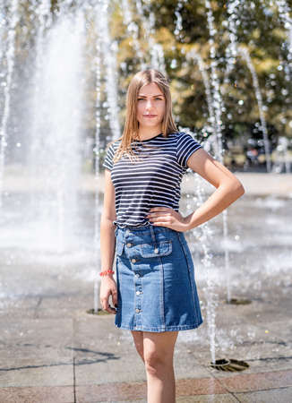 True happiness concept. Closeup portrait of young happy woman in casual clothes posing near fountainの写真素材