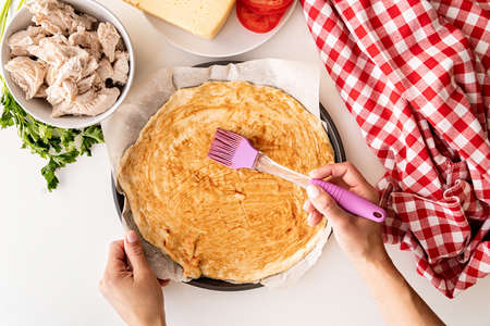 woman hands cooking pizza on white table top view flat lay