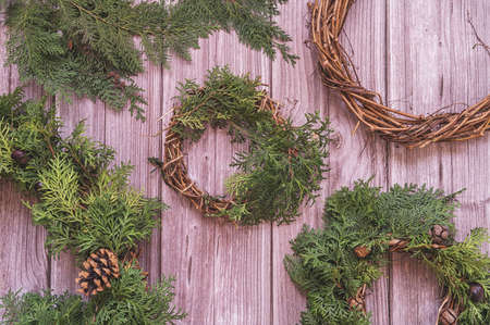hand made christmas wreathes on wooden background top view