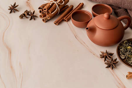 Brown chinese tea set decorated with cinnamon and other spicesの写真素材