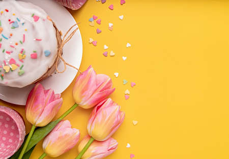 Easter holiday creative background with easter cake, tulips and decorations top view flat lay with...