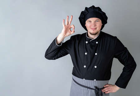 Male chef showing ok sign isolated on gray background