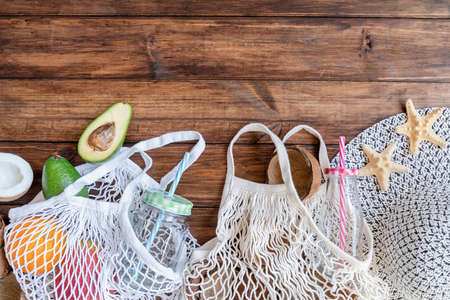 fresh tropical fruit in a mesh bag top view flat lay on wooden backgroundの写真素材