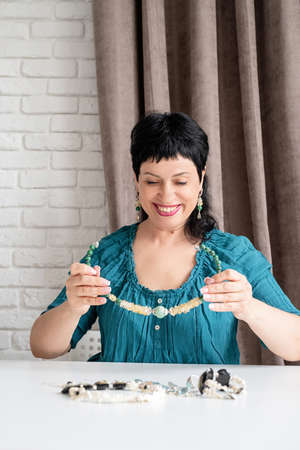 Beautiful middle aged woman looking at the jeweleryの写真素材