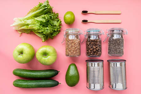 Coronavirus food supplies concept. Vegetables, canned food, wooden toothbrushes layout top view on...