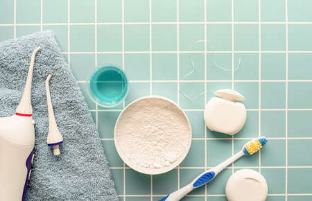 Oral hygiene, dental tools, dental floss, mouth irrigator, toothbrushes and dental powder top view...