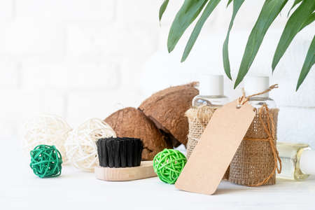 Body care concept: bottles of lotions or oils with a blank tag front view on white wooden tableの写真素材