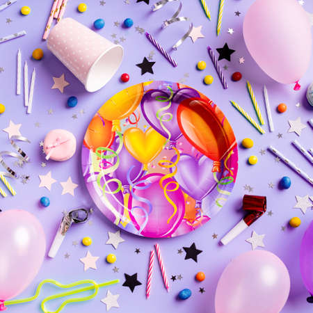 Birthday party background. Balloons, candles, confetti, candies and party supplies on blue, top view flat lay, square compositionの写真素材