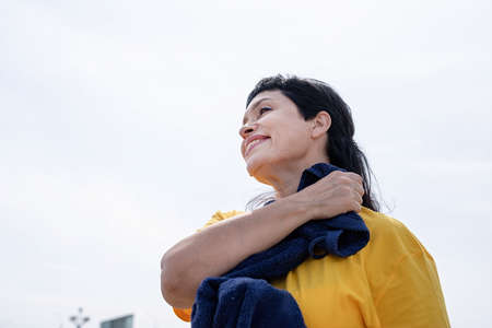 Sport and fitness. Senior sport. Active seniors. Smiling senior woman wiping out sweat after hard...