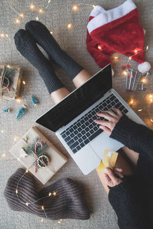 Christmas planing, online shopping concept. Top view of woman shopping online at christmas holidays...