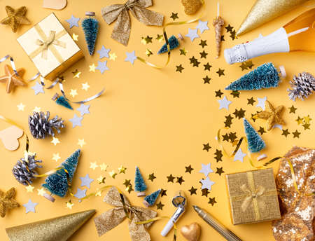 New Year and Christmas flat lay. Top view of golden christmas and new year decorations with confetti...