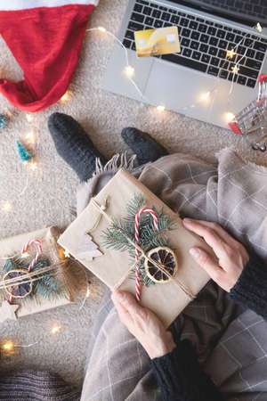 Christmas planing, online shopping concept. Top view of woman shopping online at christmas holidays...
