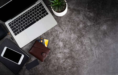 Black friday, seasonal sale concept. Laptop, smartphone, wallet and credit cards top view flat lay on dark backgroundの写真素材