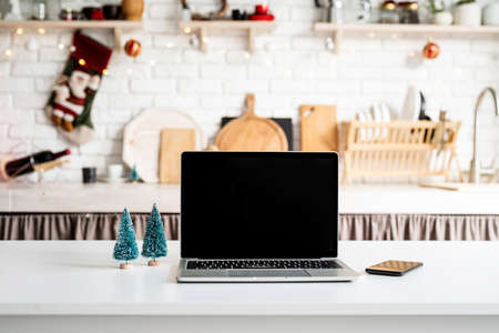 Interior light grey kitchen and red christmas decor. Festive kitchen in Christmas decorations