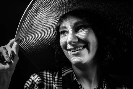 Light and shadow portrait. Beautiful young woman with a shadow pattern on the face in the form of stripesの写真素材