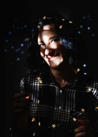 Christmas planing, online shopping concept. Young woman in santa hat shopping online surrounded by presents top view flat layの写真素材