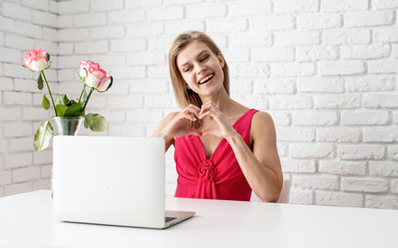 woman gaving videocall celebrating valentines day, online datingの写真素材