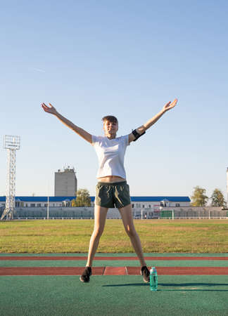 Healthy lifestyle concept. Teenage doing sports alone at the empty stadium