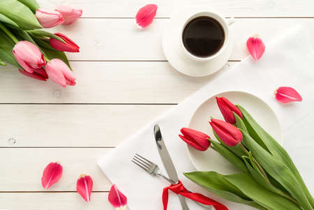 Bunch of spring tulips over white background, top view flat lay