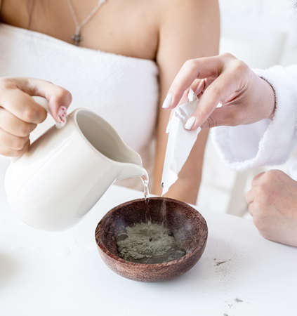 Spa and wellness concept. Self care. Women hands making facial mask doing spa proceduresの写真素材