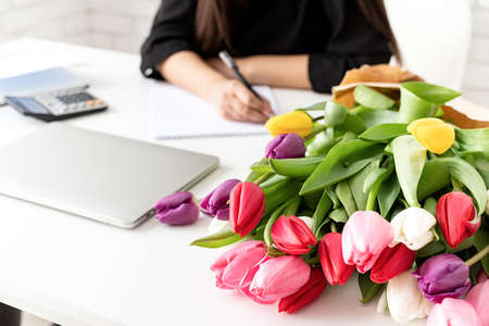 Small business concept. Portrait of young confident brunette business woman working at the office...