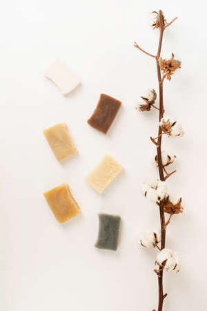 Natural cosmetics. composition with various soap and cotton branch, natural cosmetics on white...