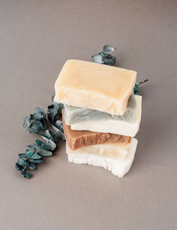 Stack of various handmade soap and eucalyptus on gray background, front viewの写真素材