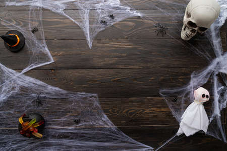 Halloween concept. Halloween holiday background with spider web and spooky decorations on black...