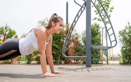 Healthy and active lifestyle. Sports and fitness. Happy woman in white t shirt working out on the...
