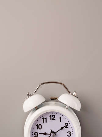 White retro alarm clock isolated on gray background with copy space