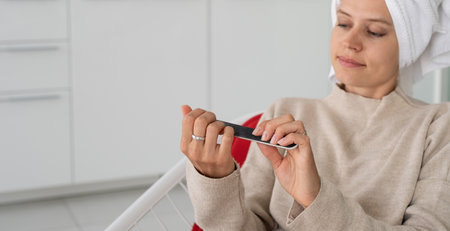 fitness, home and diet concept. Smiling young woman stretching at home, in the kitchenの写真素材