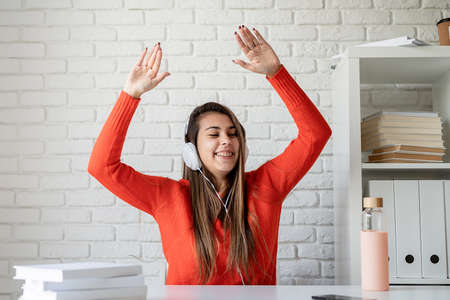 Smile happy woman getting experience using VR-headset glasses of virtual reality at home much...