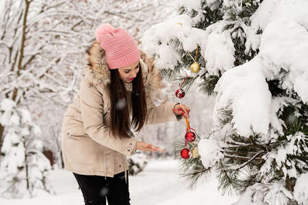 Merry Christmas and happy New Year. Beautiful woman in warm winter clothes holding mug drinking hot...