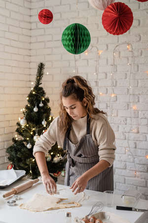 Smiling woman in the kitchen baking christmas cookiesの写真素材