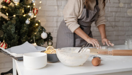 Smiling woman in the kitchen baking christmas cookiesの写真素材
