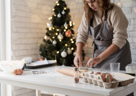 Smiling woman in the kitchen baking christmas cookiesの写真素材