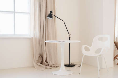 Minimal light and airy interior design, white and beige chair, rug and pillows. Airy and bright spaceの写真素材