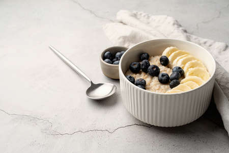 Oatmeal. Porridge with bananas and blueberries for healthy breakfast or lunch. Natural ingredients...