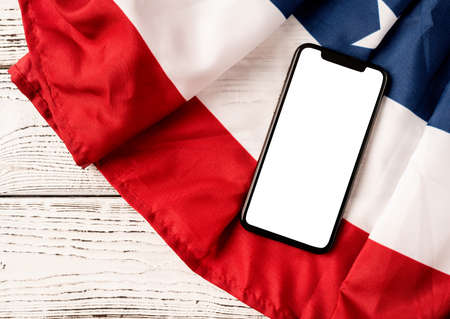 USA Memorial day, Presidents day, Veterans day, Labor day, or 4th of July celebration. Blank screen on modern smartphone for mockup design on USA national flagの写真素材