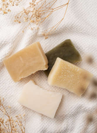 natural cosmetics. Handmade soap bars on white bathtowel top view. mock up design