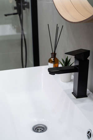 Large mirror over vessel sink in stylish bathroom interior