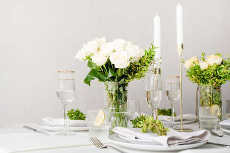 Wedding table set up in traditional style with roses grass and greenery. wedding tablescapes