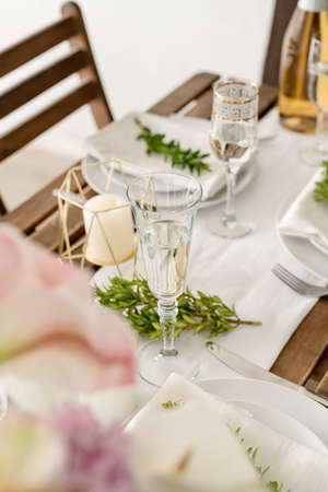 The wedding table setting and decor on wooden table in rustic style. Wedding tablescapes. Table set...