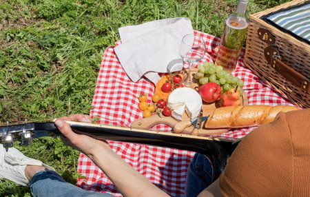 Young woman in park outside at sunny day, enjoying summertime dreaming and drinking wine. Millennial...