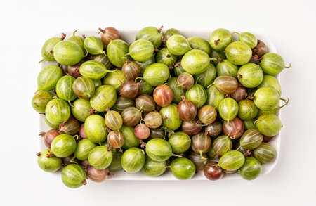 fresh ripe gooseberries texture on a plate, flat layの写真素材