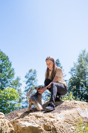 pet care. Travelling. Young pretty caucasian woman smiling holding small dog yorkshire terrier. Woman travel with pet. selective focusの写真素材