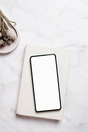 smartphone with isolated screen on marble deskの写真素材