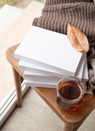 back to school. Cozy autumn. Study and education concept. Stack of white blank books with autumn...